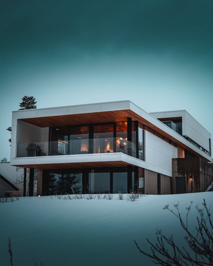 Stunning modern home with glass facade in snowy Troms, Norway, during winter.
